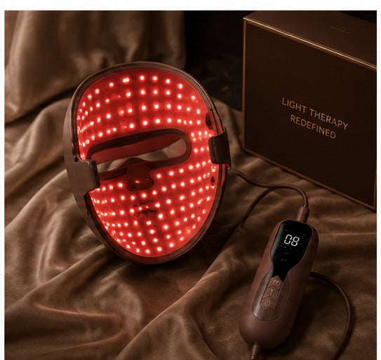 Luxera LED mask glowing warm red during an evening light session