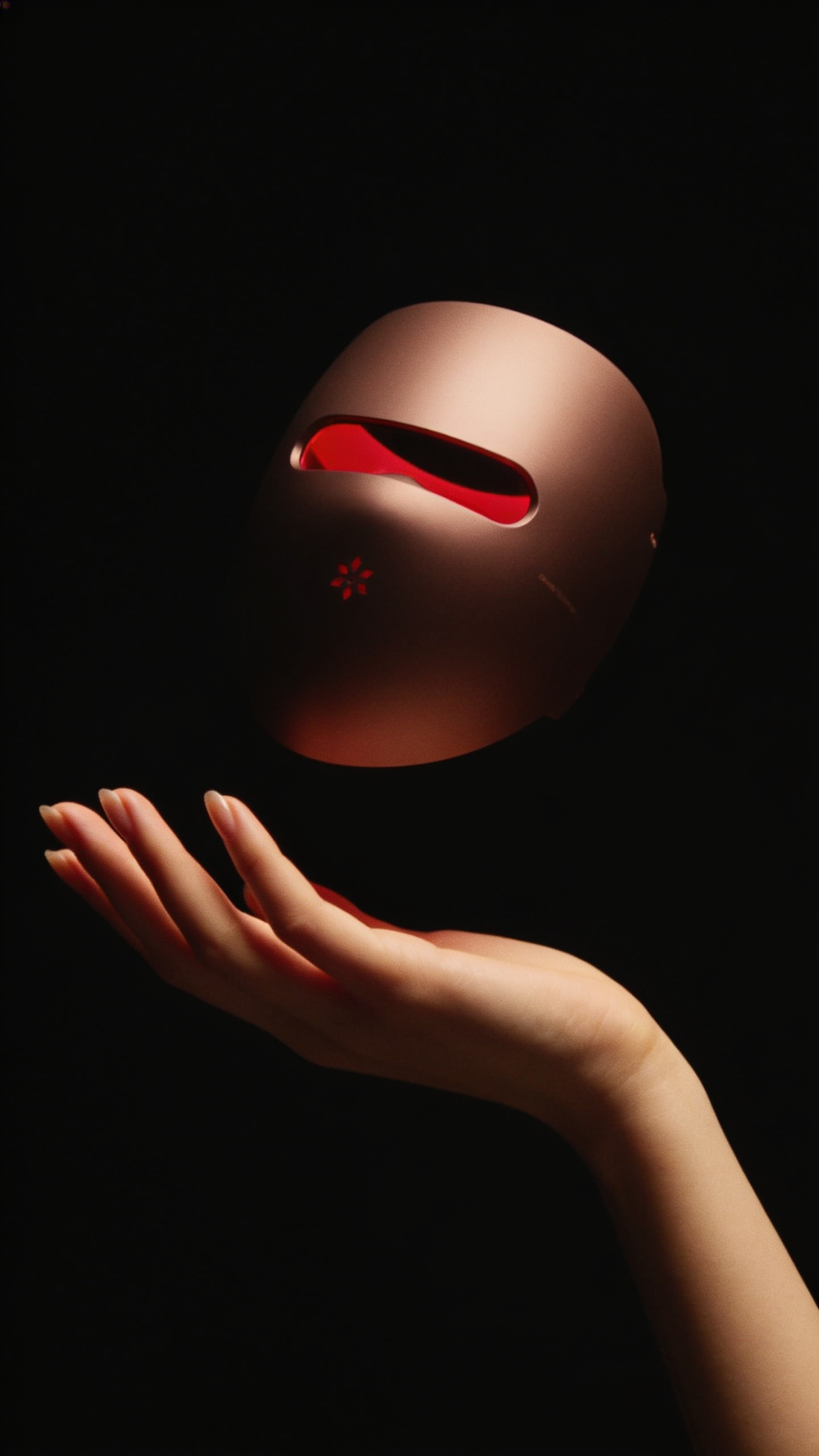 LuxeraSkin LED Mask levitating above open palm, red light glow